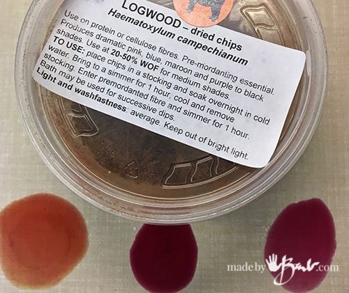 container of logwood chips and drops of dye with different colours