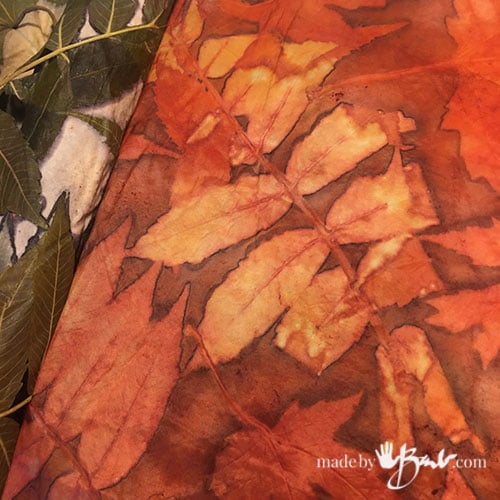 Reddish eco print showing sumac leaf details